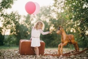 Photo by Photographer in Mallorca - Romany Flower. artistic children portrait of girl with wooden horse