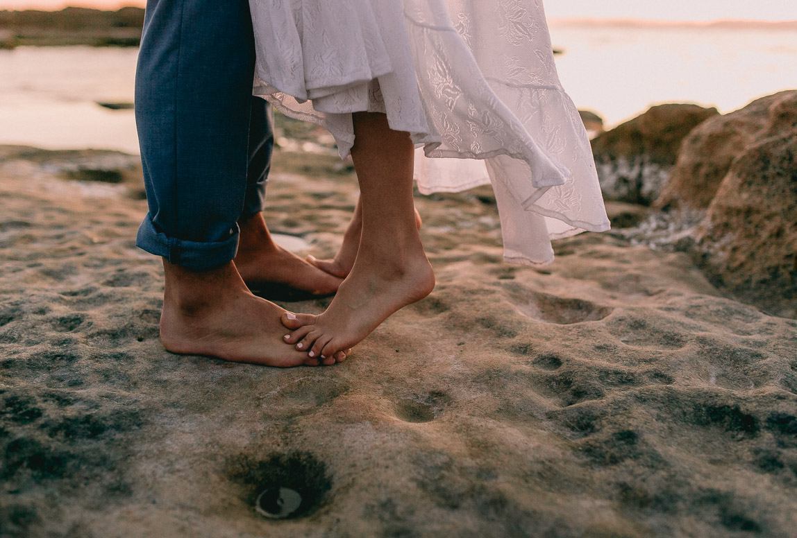 Palma de mallorca after wedding photographer - bride standing on tiptoe photo at the beach during sunset