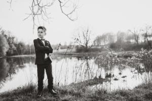 palma de Mallorca family photoshoot - young boy looking handsome and posing by a lake