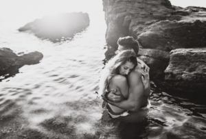 couple photographer majorca - intimate couple hugging in the water during photoshoot