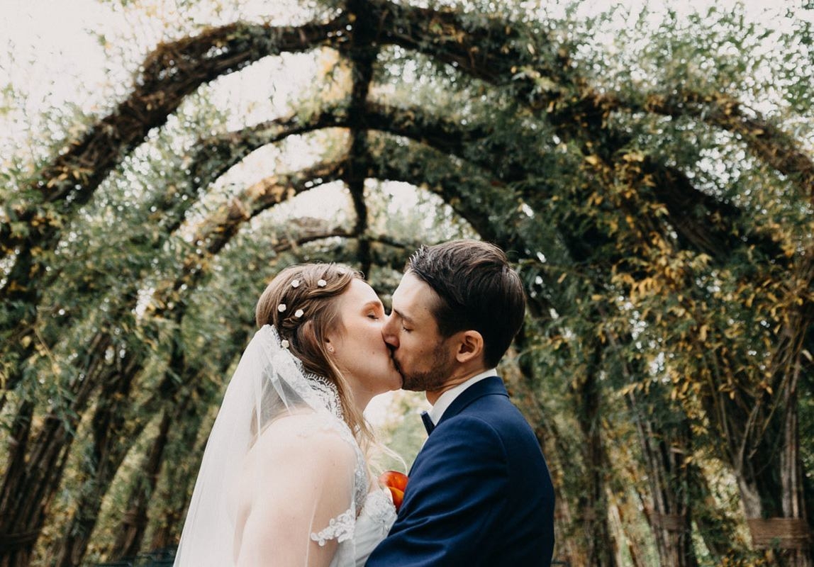 Bride and groom kiss at outdoor finca wedding - photograph by mallorca elopement photographer romany flower