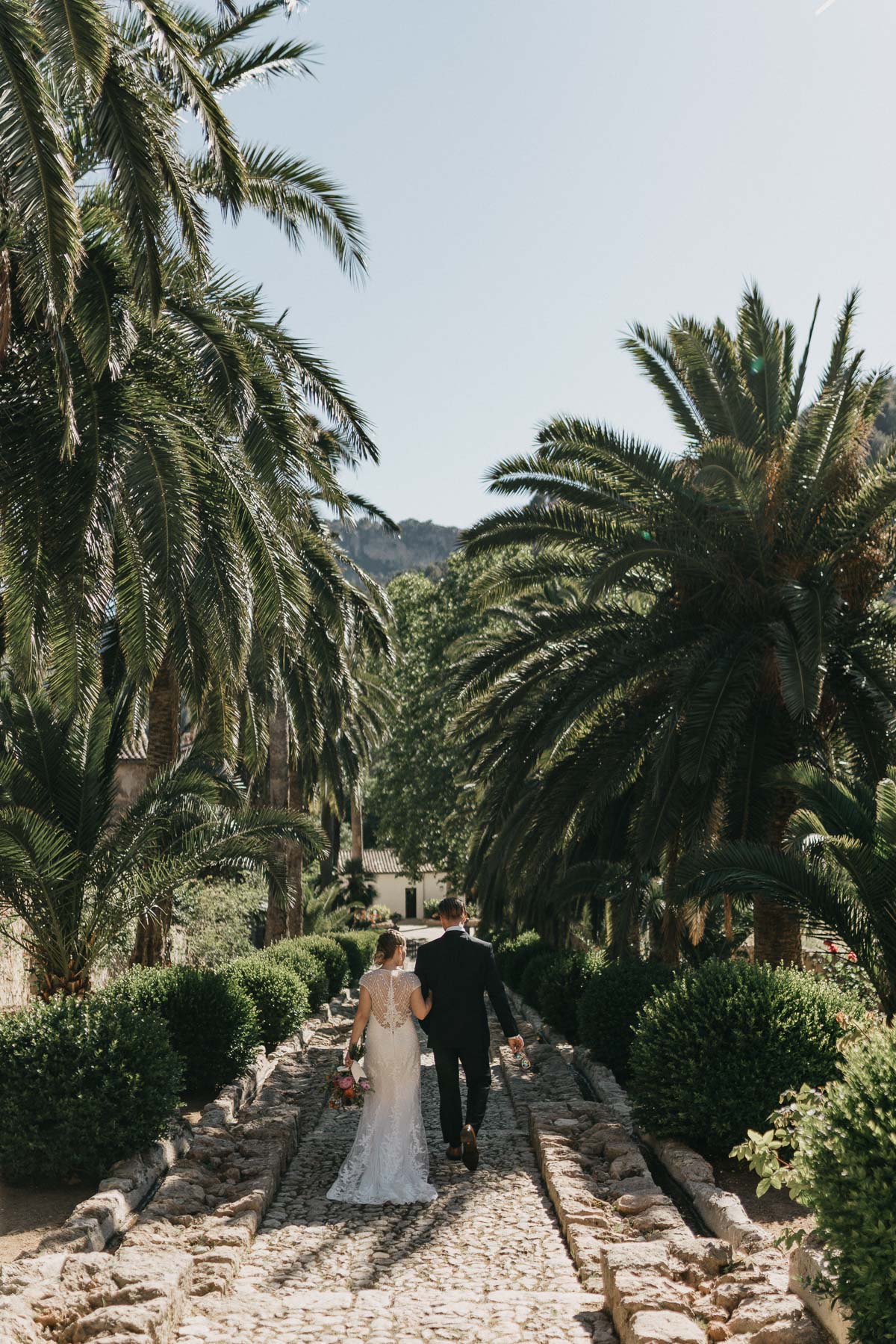 Deia Wedding photographer: Couple walking through gardens of alfabia