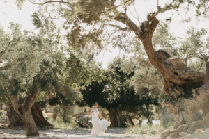 Adventure wedding spain: bride dancing in olive grove