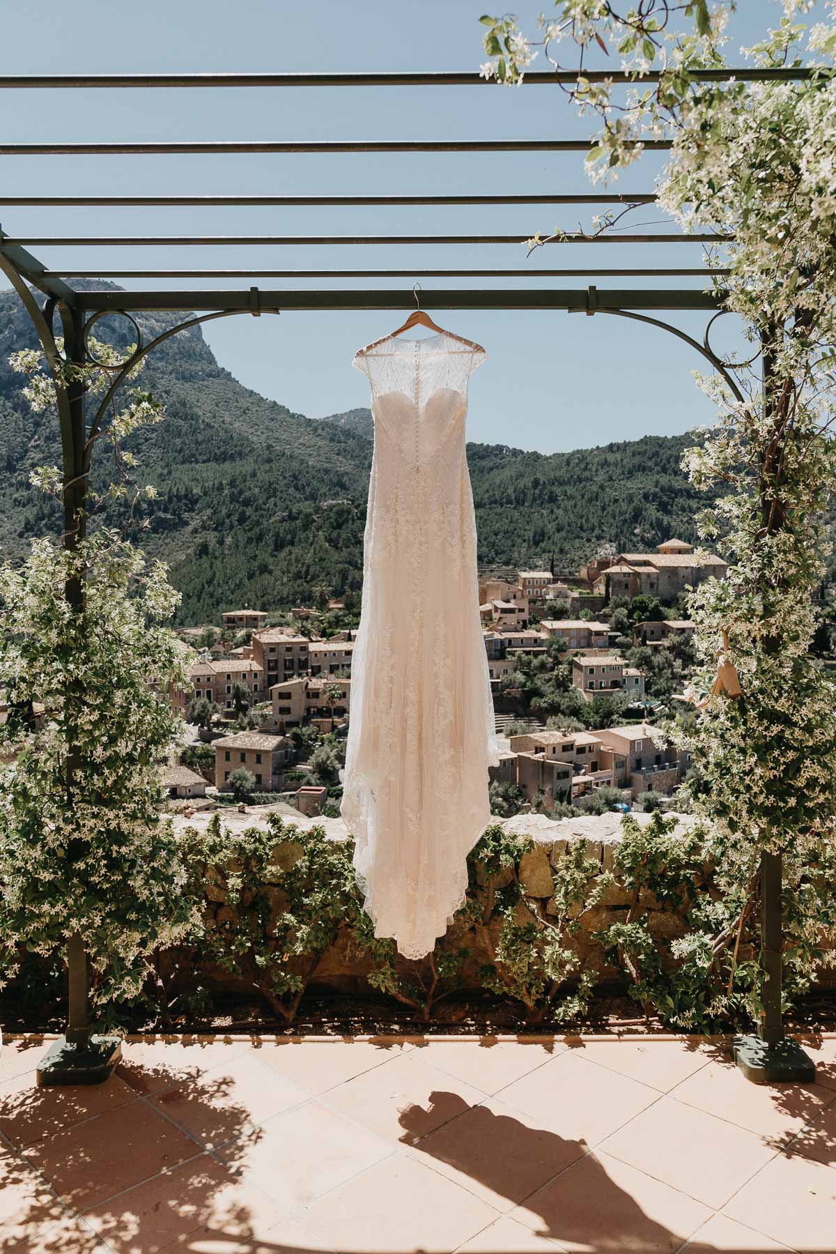 elopement photography in Spain: Dress hanging outdoors against scenic view in Mallorca, Spain